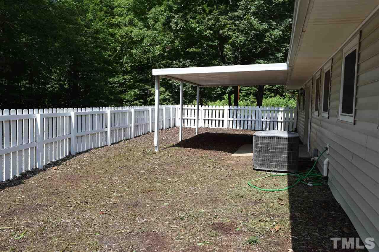 89 Mountain Ridge Road Rougemont, NC 27572 - Photo 3 of 16 a view of a deck with a wooden fence