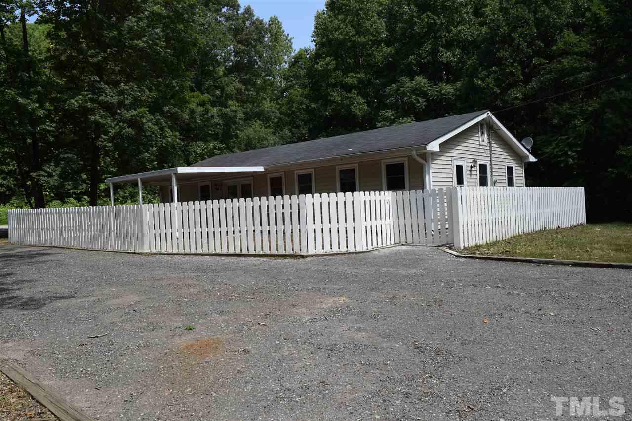 89 Mountain Ridge Road Rougemont, NC 27572 - Photo 4 of 16 a front view of a house with a yard and fence