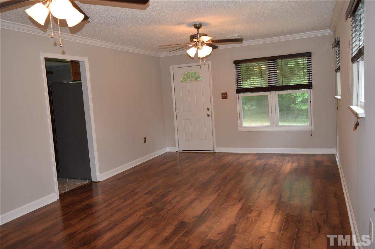 89 Mountain Ridge Road Rougemont, NC 27572 - Photo 9 of 16 a view of an empty room with wooden floor and a window