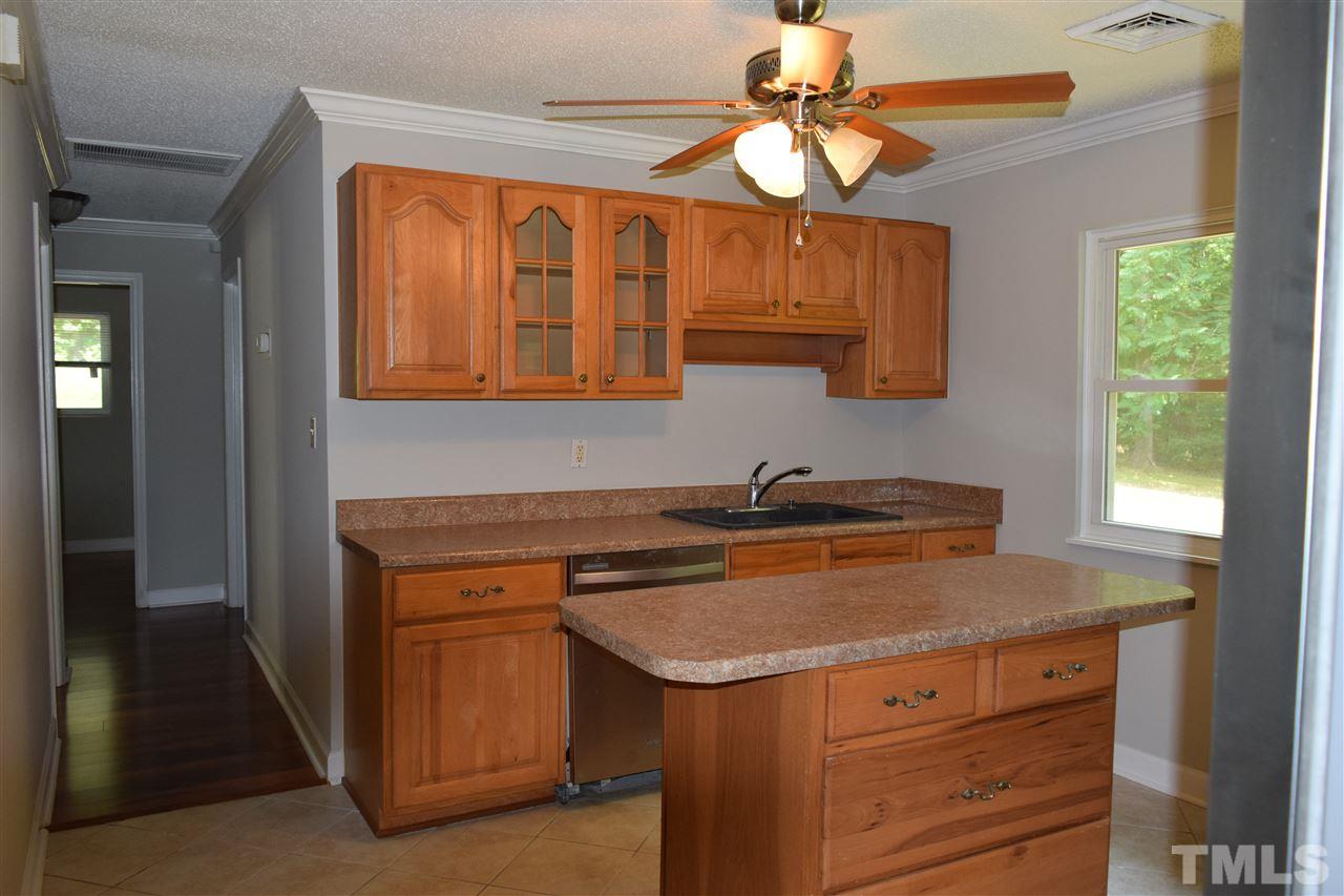 89 Mountain Ridge Road Rougemont, NC 27572 - Photo 10 of 16 a kitchen with a stove cabinets and a window