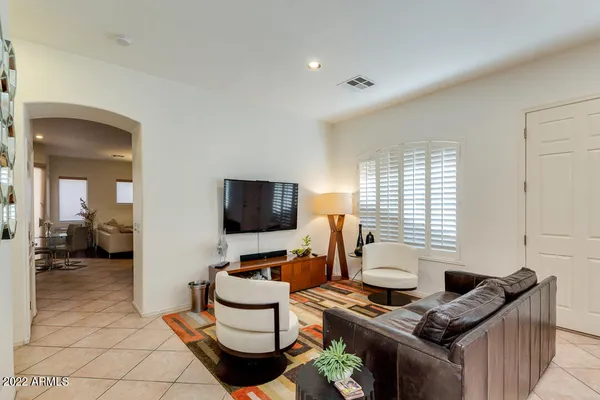 a work room with furniture and a flat screen tv