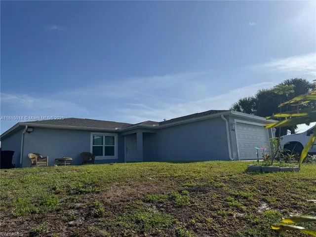 a front view of house with a garden