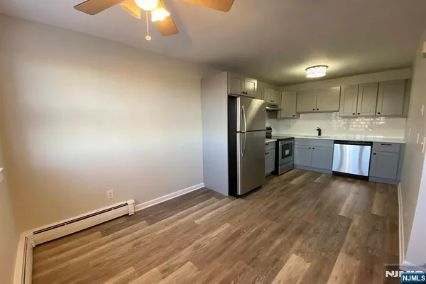 a kitchen with stainless steel appliances a refrigerator and a stove top oven