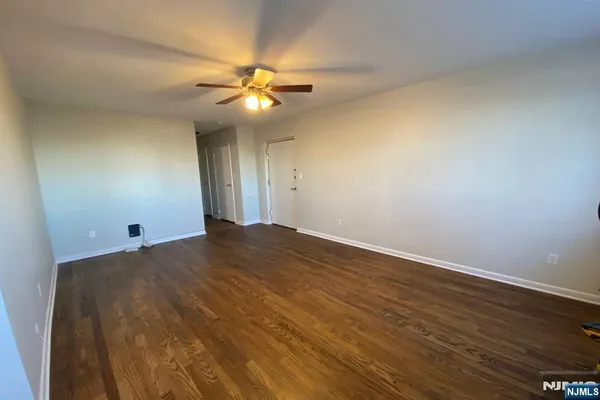 a view of a big room with wooden floor and closet area