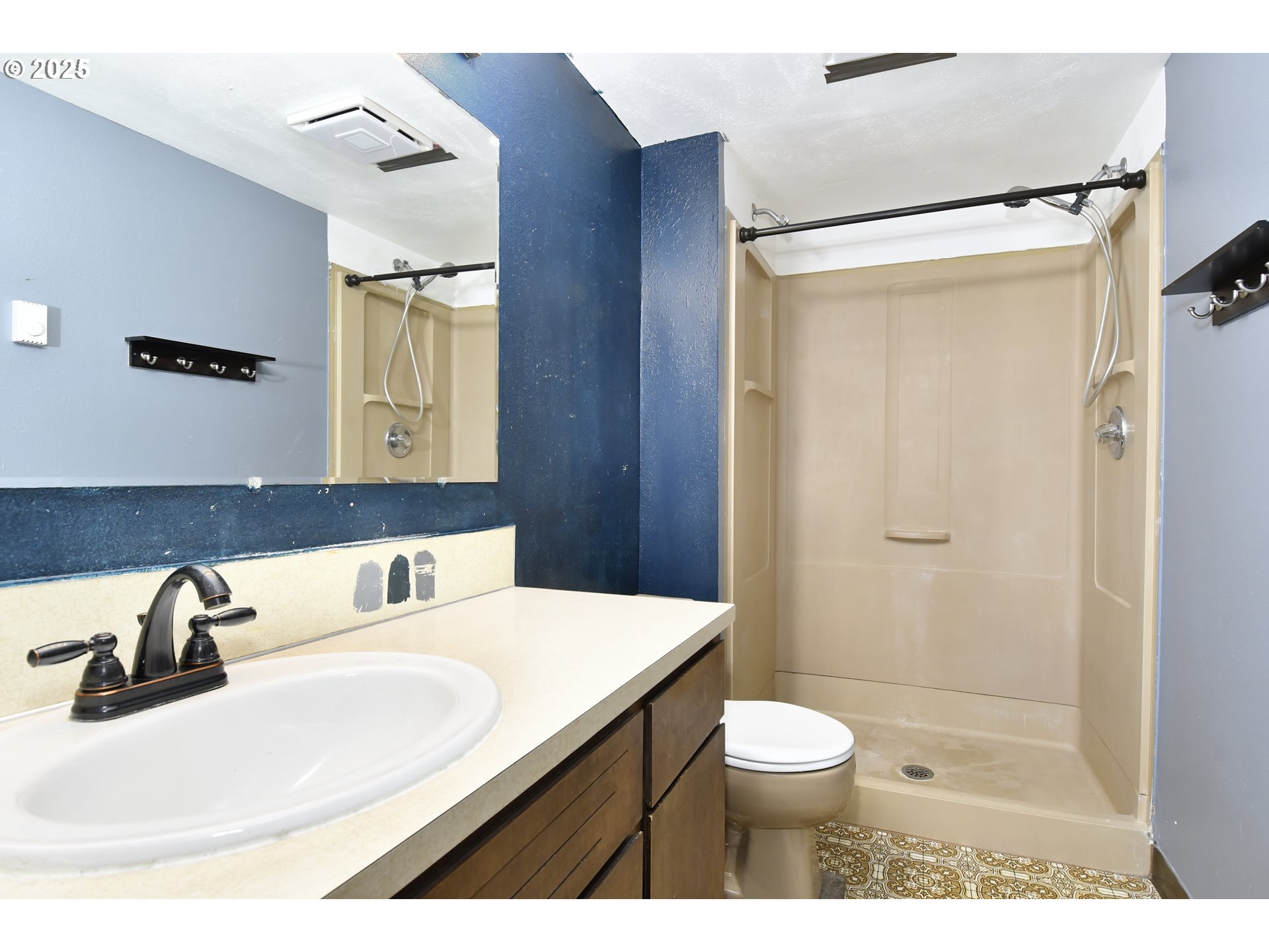 1226 Southwest Hensley Road Troutdale, OR 97060 - Photo 27 of 40 a bathroom with a sink toilet a mirror and shower