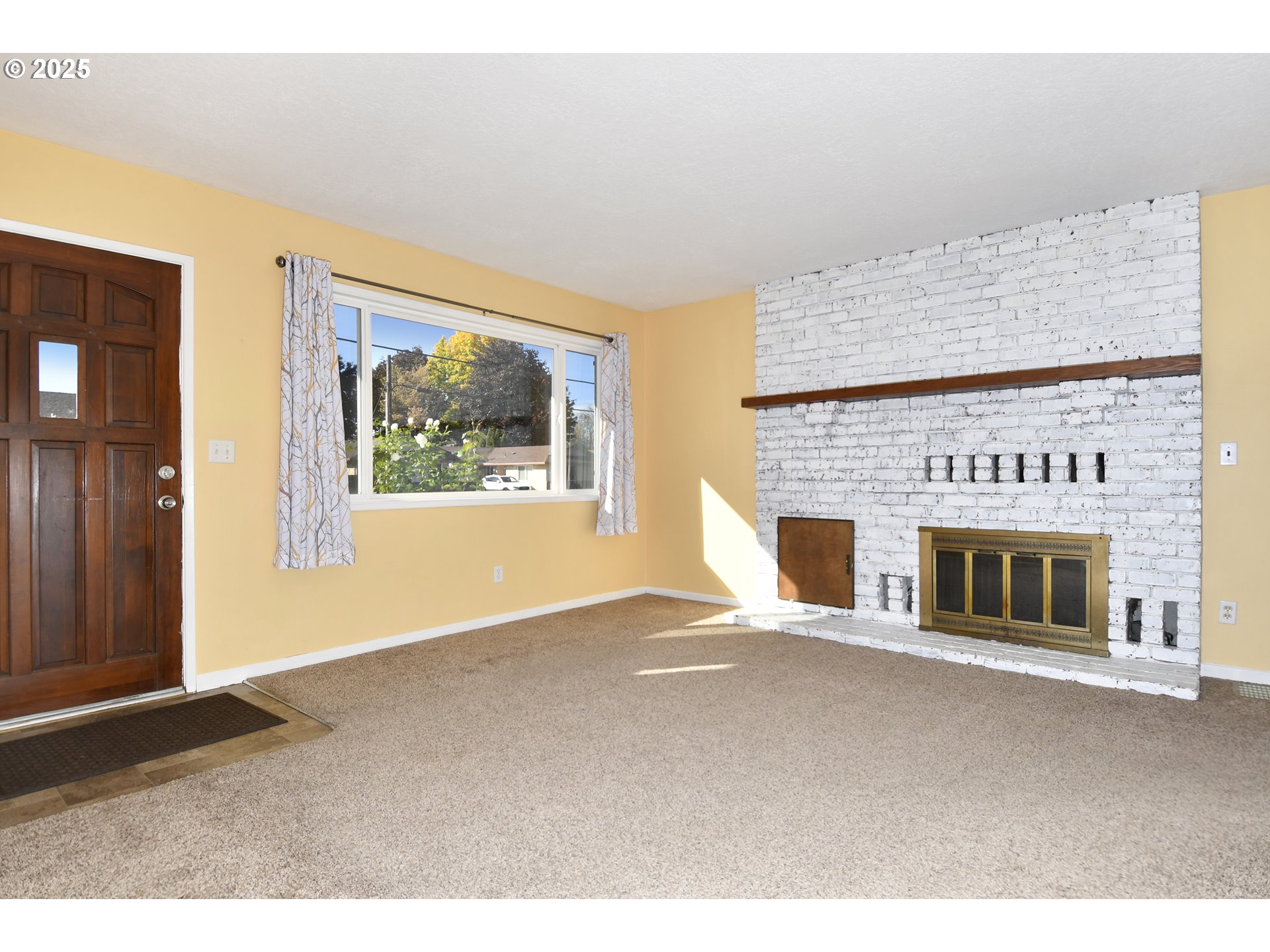 1226 Southwest Hensley Road Troutdale, OR 97060 - Photo 8 of 40 a view of an empty room with a fireplace and a window