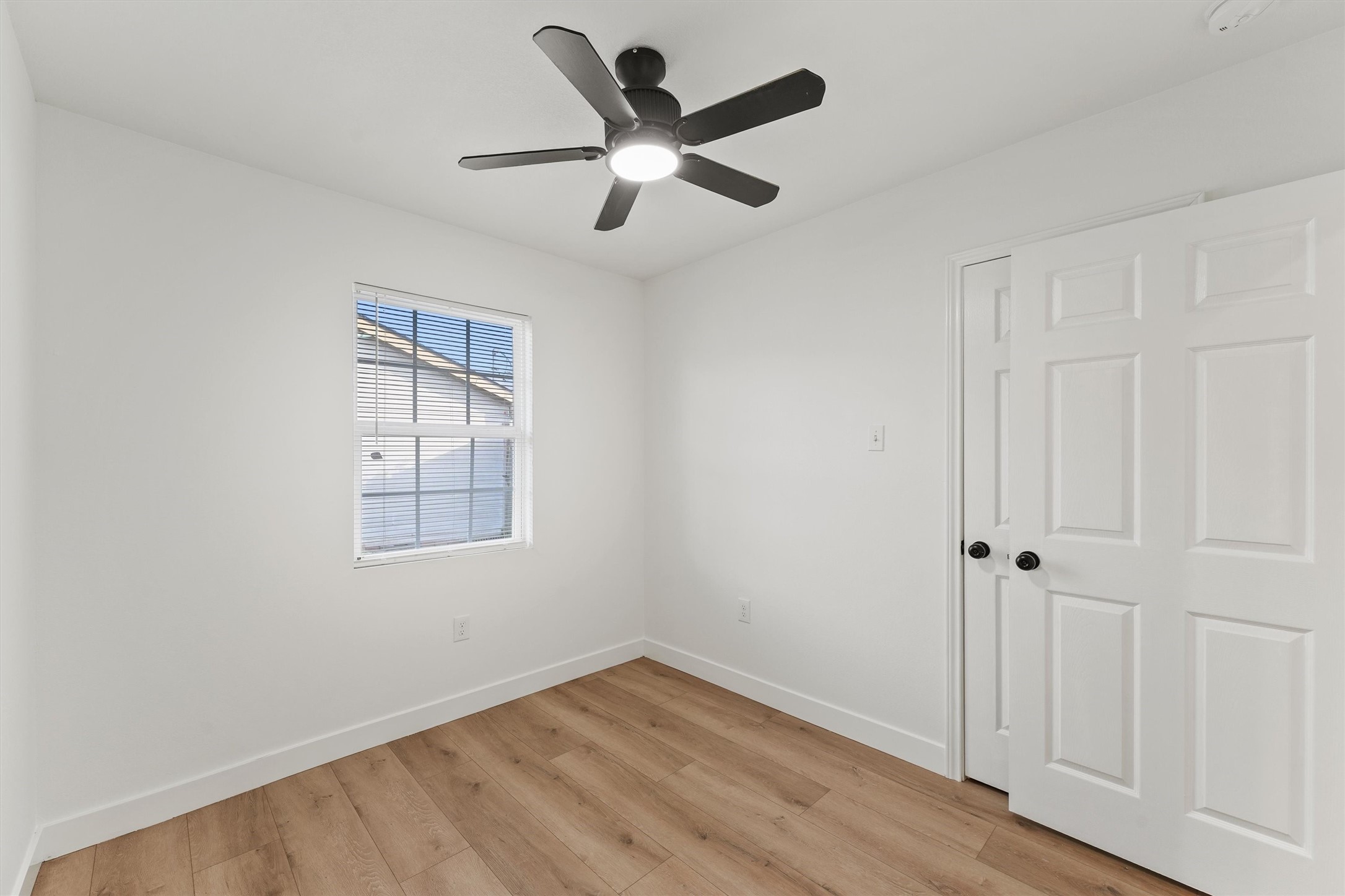 5406 Firefly Street Houston, TX 77017 - Photo 14 of 29 an empty room with wooden floor ceiling fan and windows