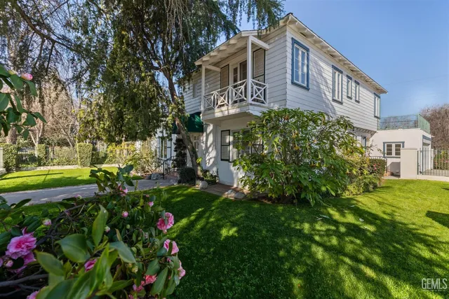 a view of a house with a yard and garden