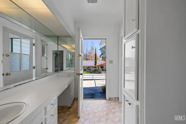 a bathroom with a sink a mirror and a shower