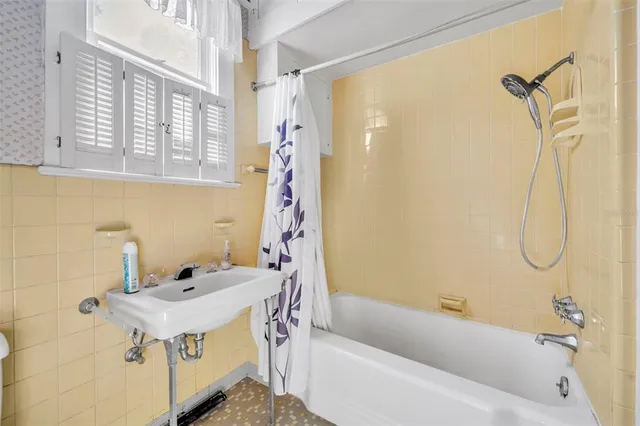 a bathroom with a sink a mirror and a bathtub