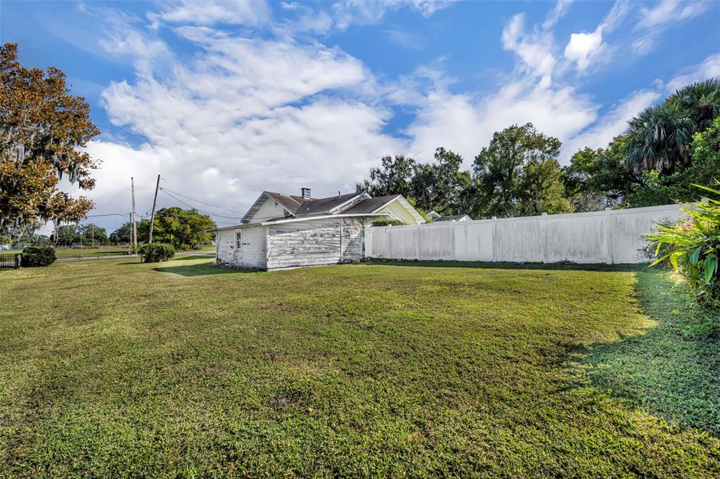 207 Perkins Street Leesburg, FL 34748 - Photo 24 of 31 a view of a house with a yard