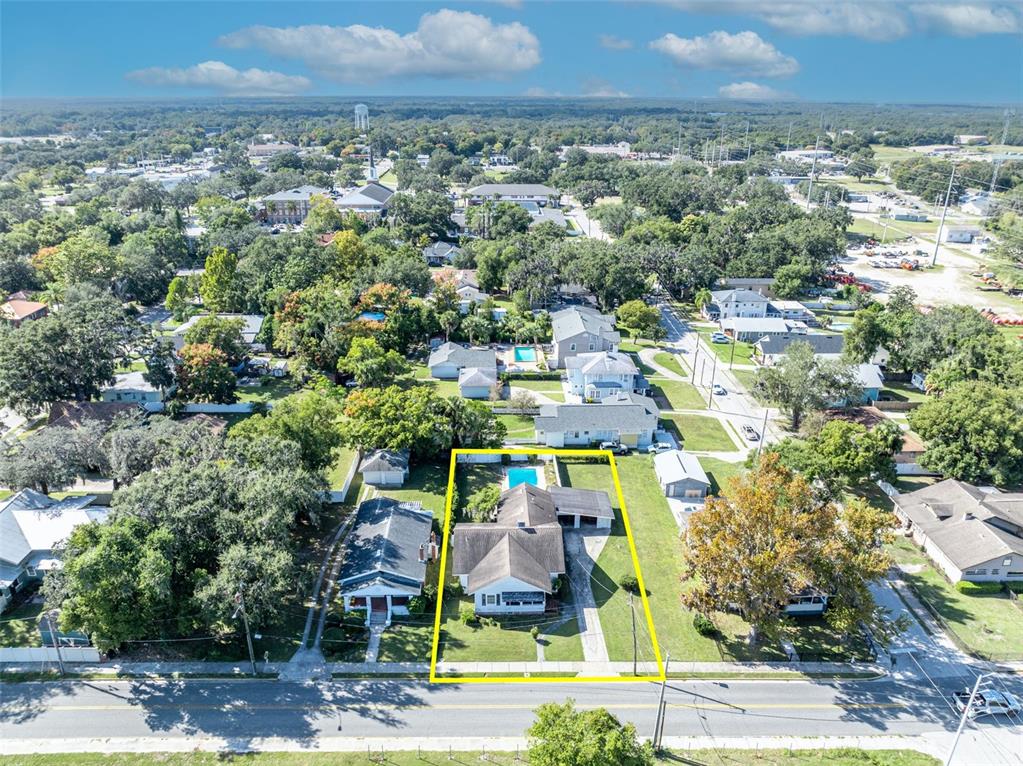 207 Perkins Street Leesburg, FL 34748 - Photo 28 of 31 an aerial view of residential houses with outdoor space and parking
