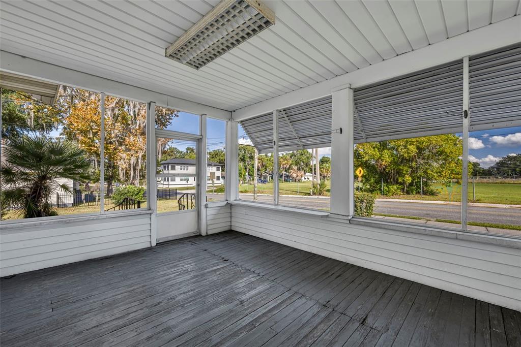 207 Perkins Street Leesburg, FL 34748 - Photo 3 of 31 a view of room with window and wooden floor