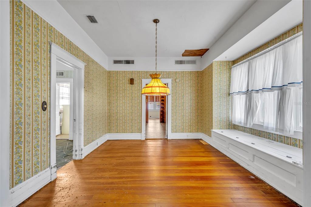 207 Perkins Street Leesburg, FL 34748 - Photo 7 of 31 a view of a room with wooden floor and staircase