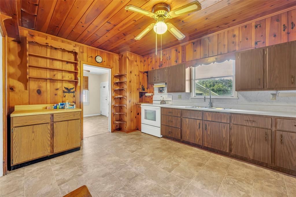 207 Perkins Street Leesburg, FL 34748 - Photo 10 of 31 a kitchen with sink cabinets and window
