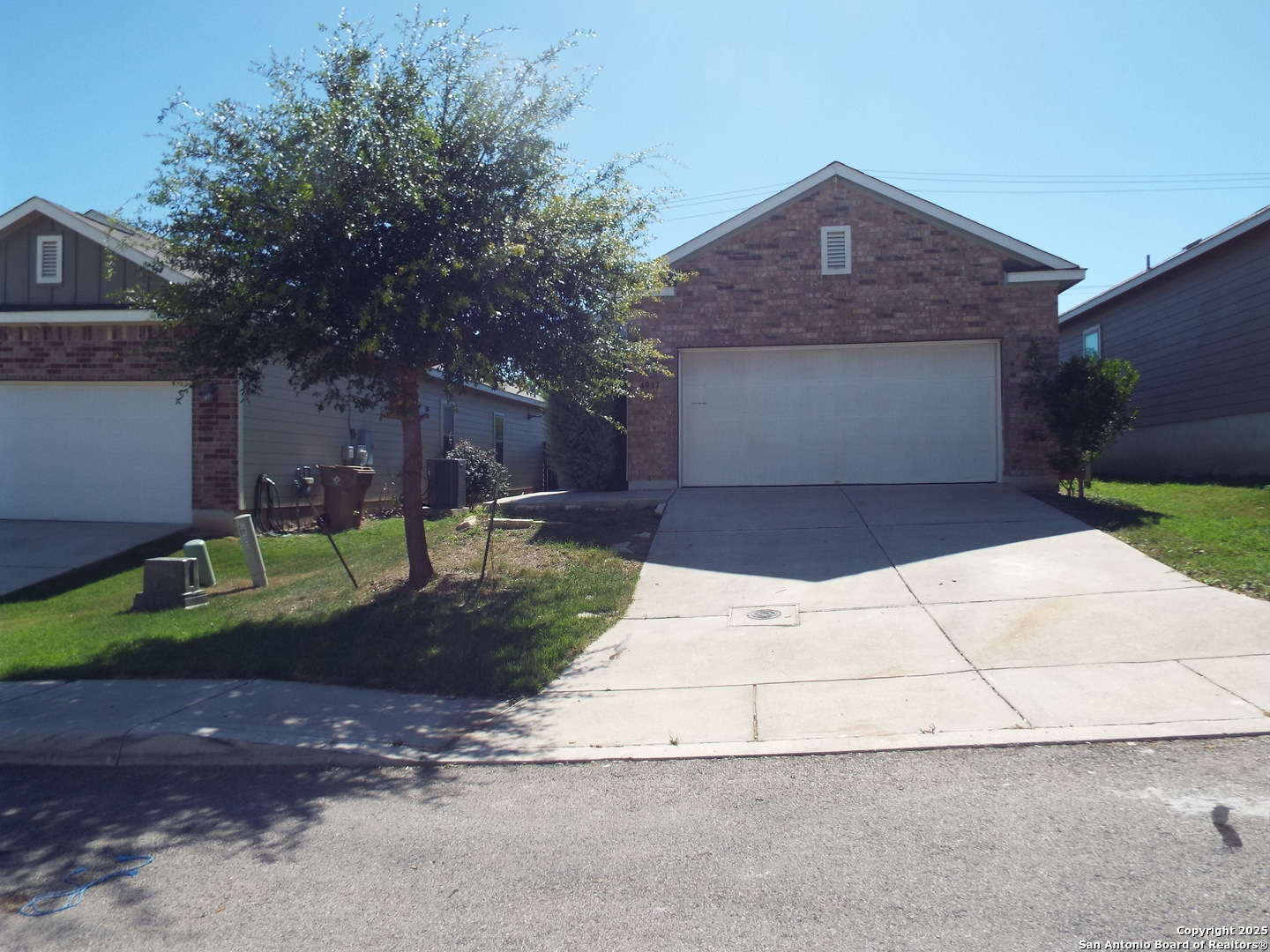 4937 Hallies Garden St. Hedwig, TX 78152 - Photo 2 of 30 a front view of a house with a yard and garage