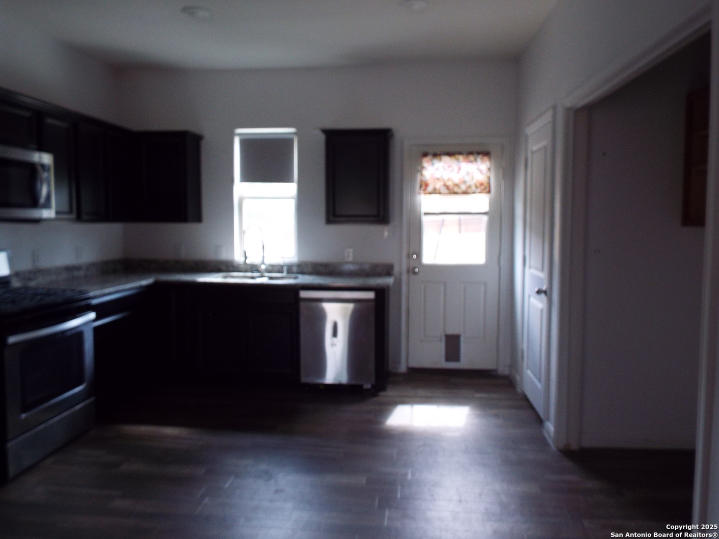 4937 Hallies Garden St. Hedwig, TX 78152 - Photo 28 of 30 a kitchen with granite countertop stainless steel appliances and wooden cabinets