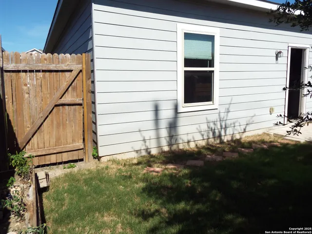 a view of house with backyard