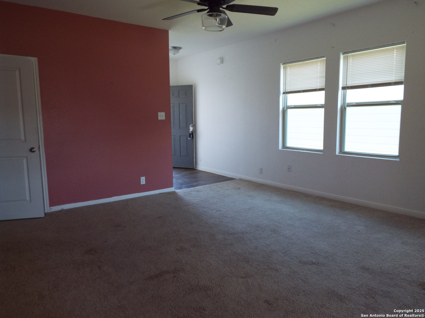 4937 Hallies Garden St. Hedwig, TX 78152 - Photo 8 of 30 an empty room with a window and a ceiling fan