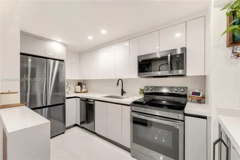a kitchen with a sink stove and refrigerator