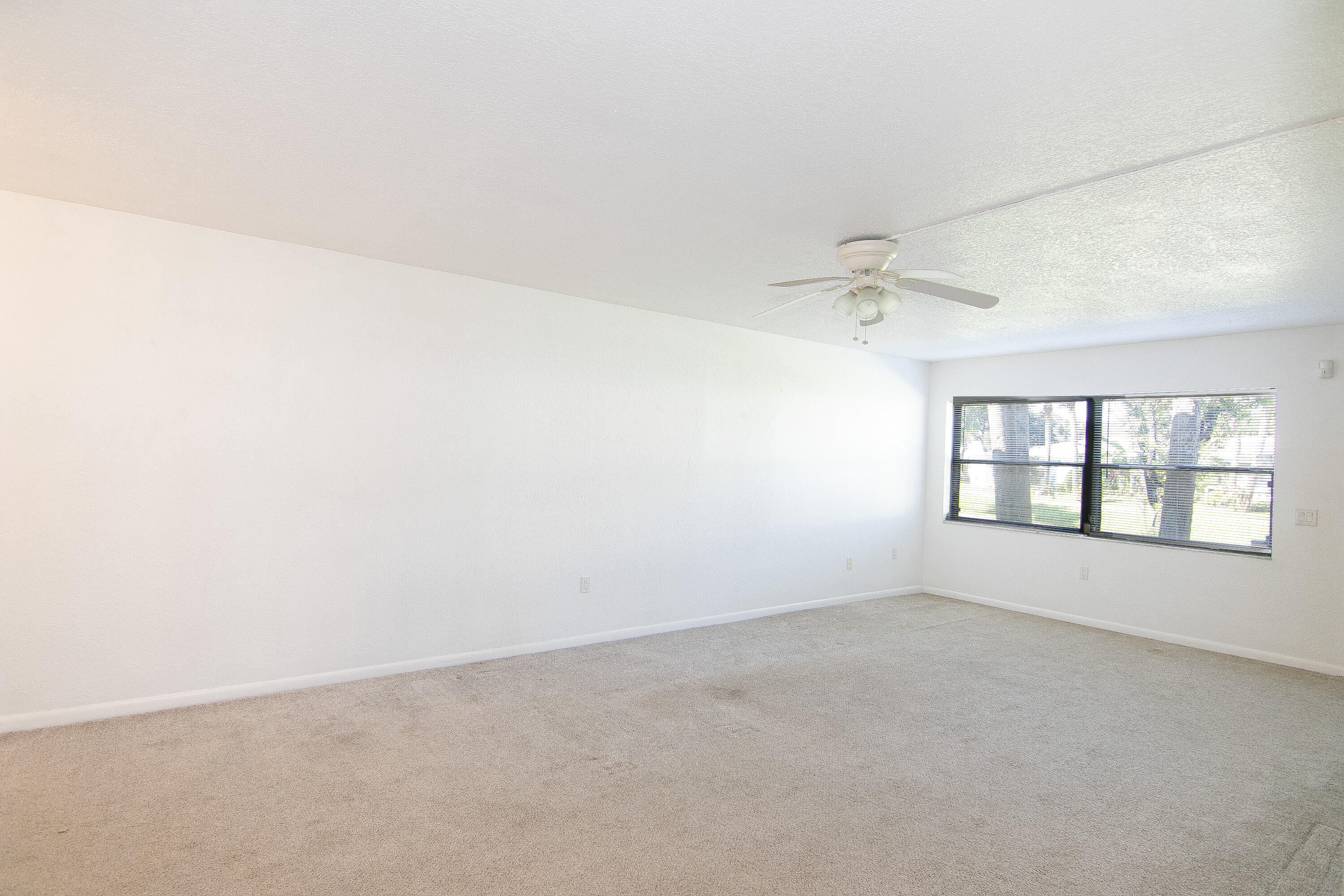 3130 Southwest 20th Terrace, Unit 13B1 Delray Beach, FL 33445 - Photo 15 of 47 an empty room with a empty space and windows