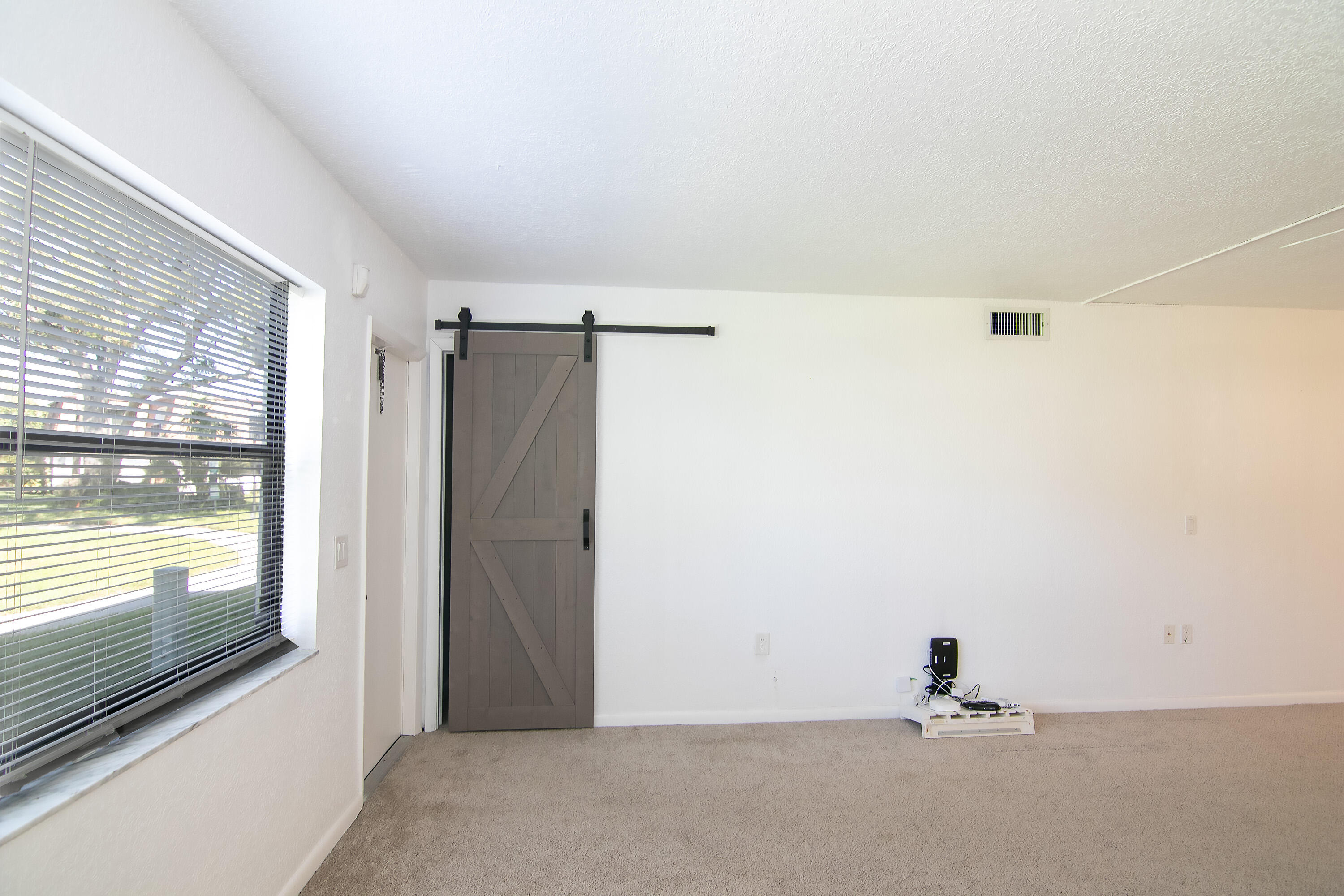 3130 Southwest 20th Terrace, Unit 13B1 Delray Beach, FL 33445 - Photo 16 of 47 a view of a room with a sliding door