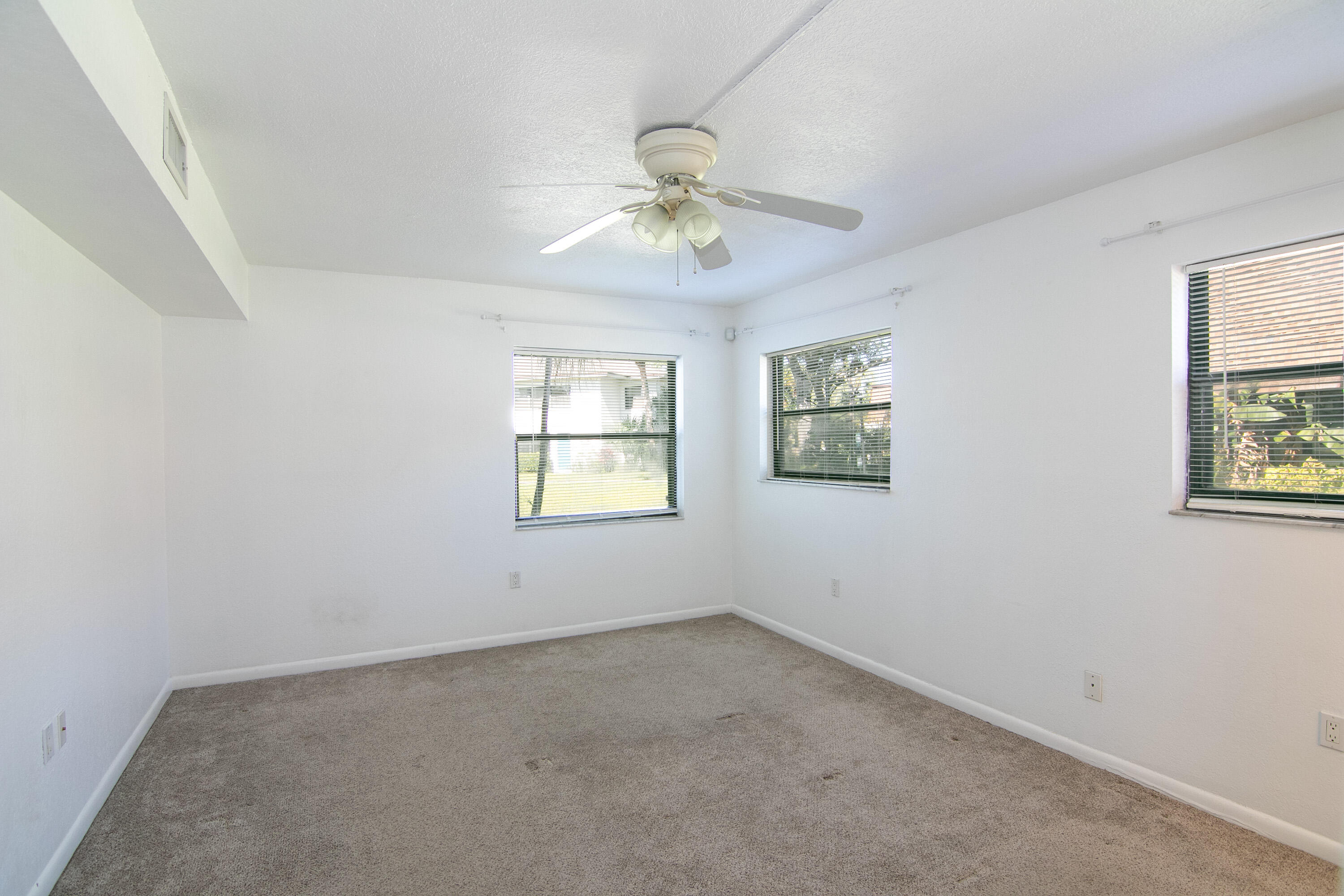 3130 Southwest 20th Terrace, Unit 13B1 Delray Beach, FL 33445 - Photo 21 of 47 an empty room with a window and a fan