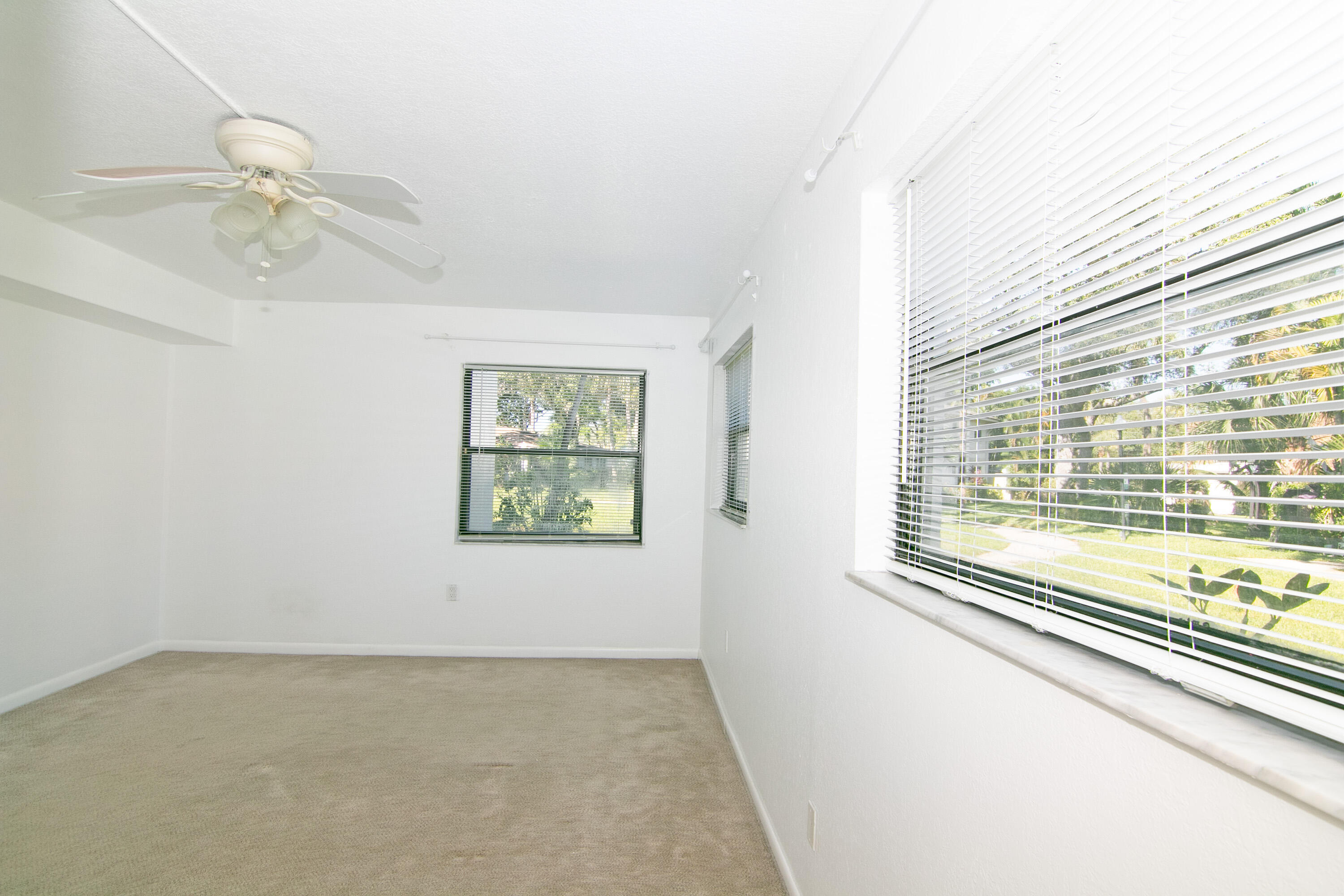 3130 Southwest 20th Terrace, Unit 13B1 Delray Beach, FL 33445 - Photo 22 of 47 an empty room with windows