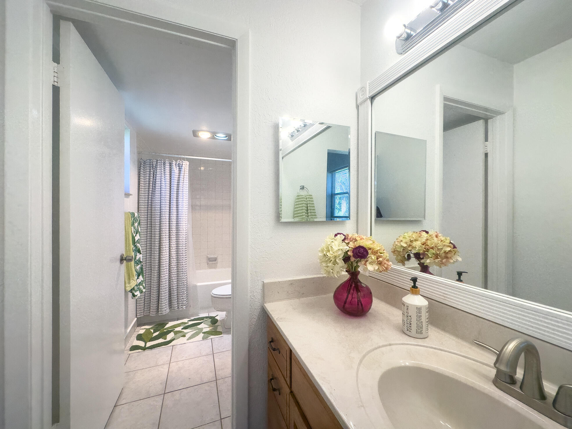 3130 Southwest 20th Terrace, Unit 13B1 Delray Beach, FL 33445 - Photo 24 of 47 a bathroom with a sink and a mirror
