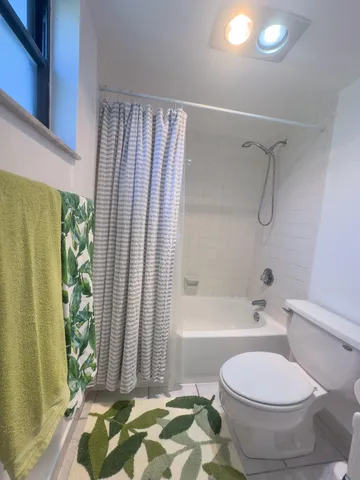 a spacious bathroom with a double vanity sink toilet and a mirror
