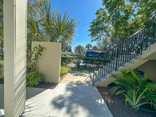 a view of a house with swimming pool and sitting area