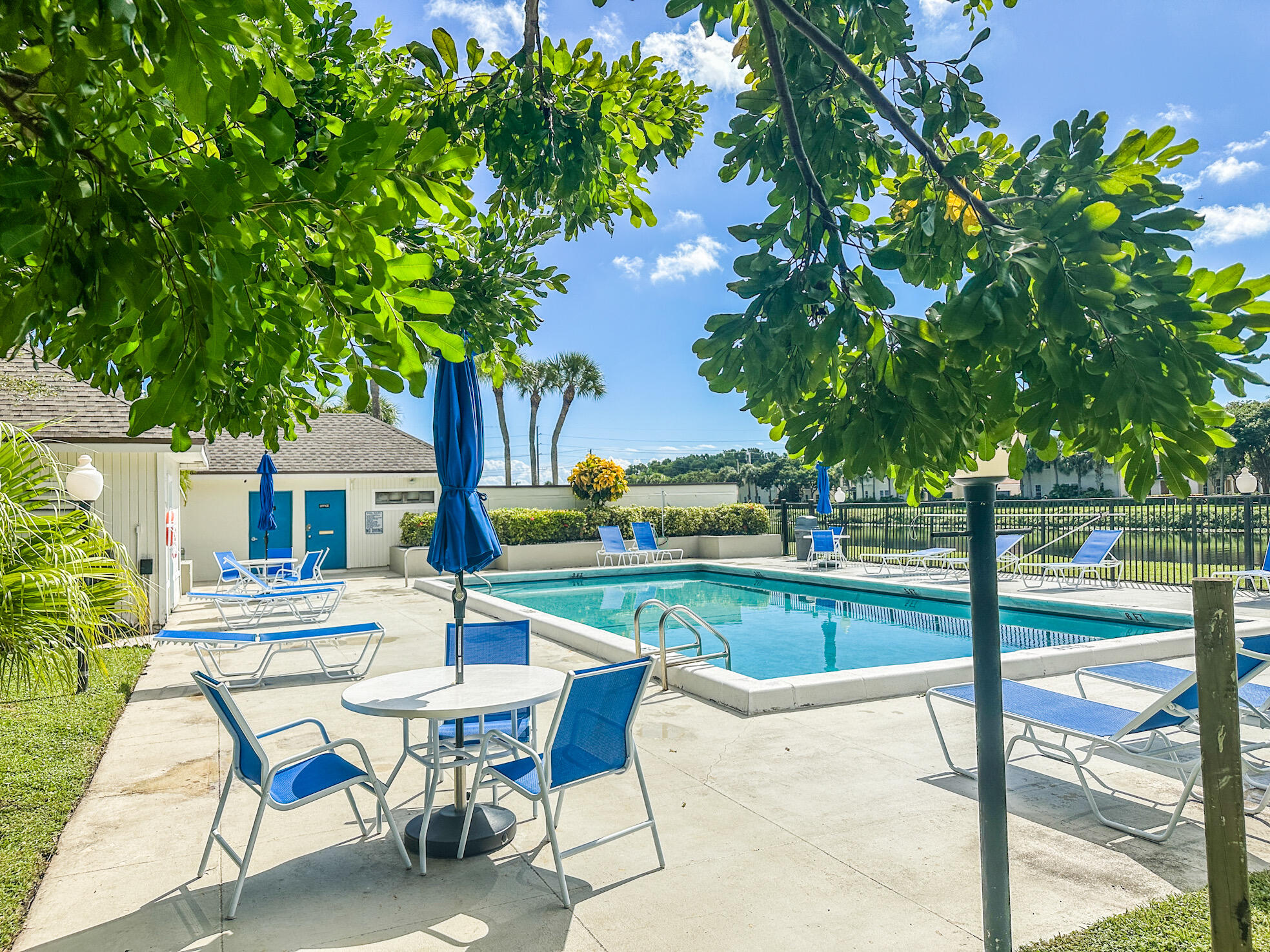 3130 Southwest 20th Terrace, Unit 13B1 Delray Beach, FL 33445 - Photo 35 of 47 a view of a house with backyard sitting area and garden