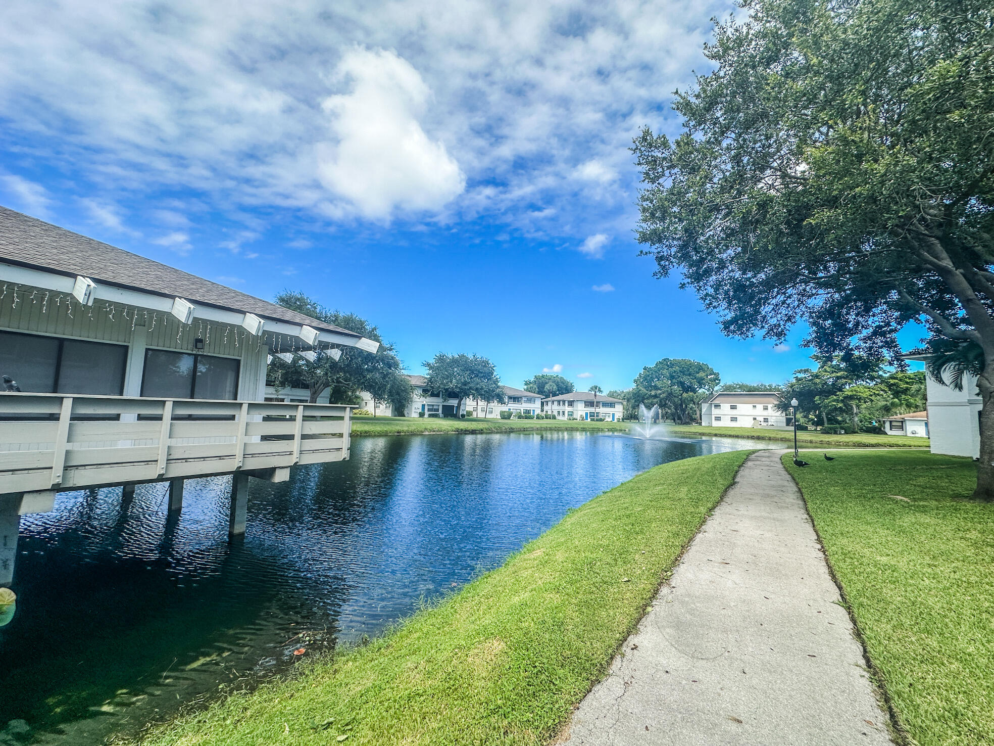 3130 Southwest 20th Terrace, Unit 13B1 Delray Beach, FL 33445 - Photo 39 of 47 a view of a lake with houses