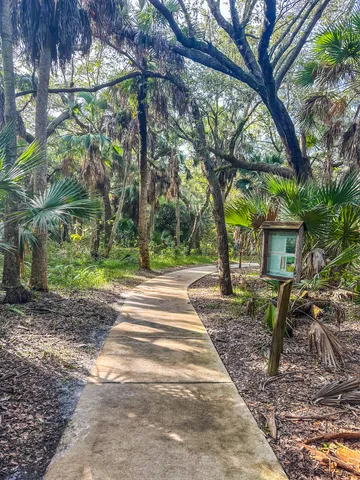 a view of a patio with table and chairs potted plants with wooden fence