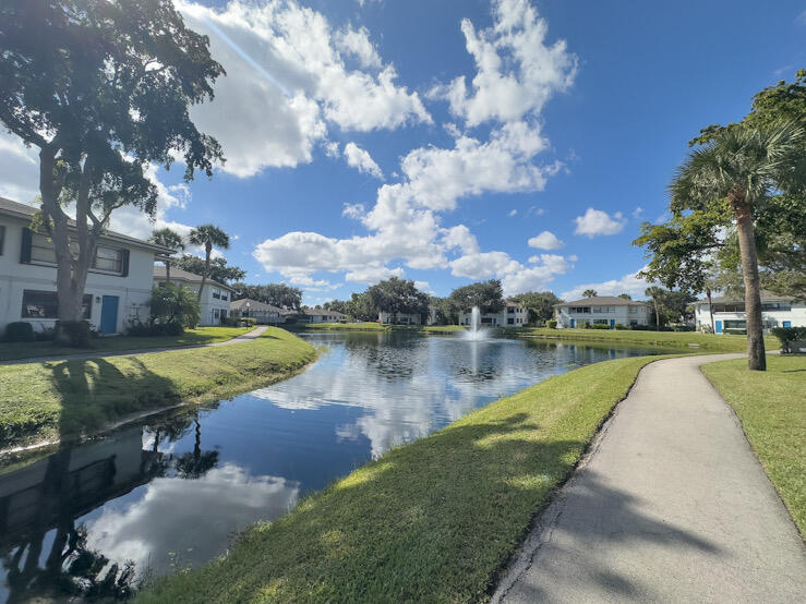 3130 Southwest 20th Terrace, Unit 13B1 Delray Beach, FL 33445 - Photo 47 of 47 a view of a lake with a yard