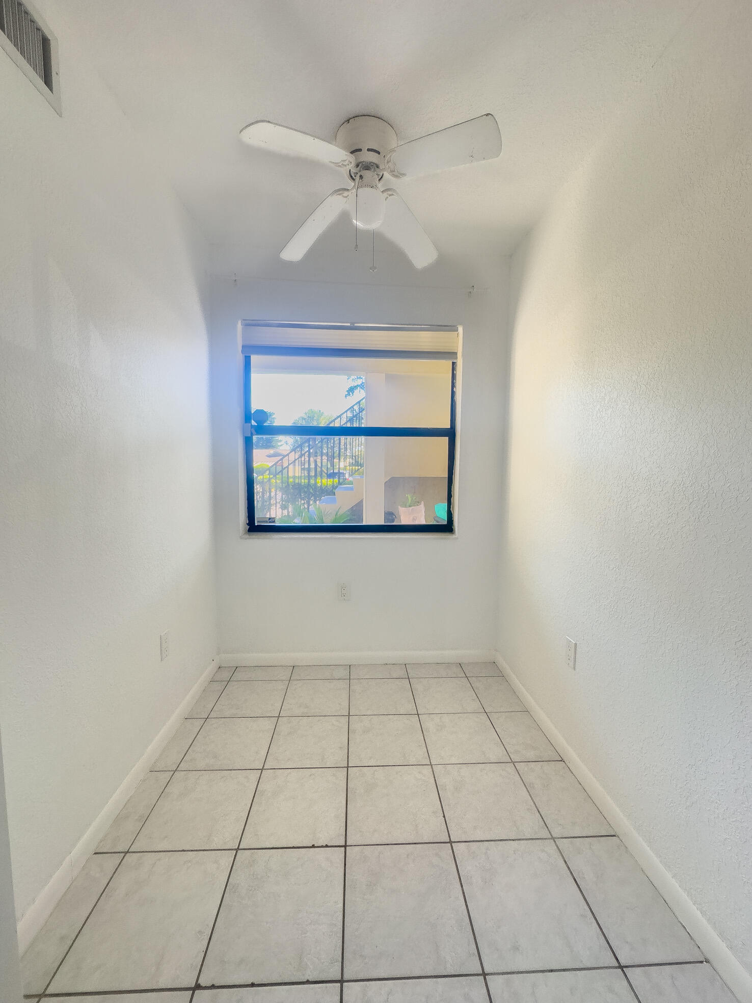 3130 Southwest 20th Terrace, Unit 13B1 Delray Beach, FL 33445 - Photo 9 of 47 a view of an empty room with a window