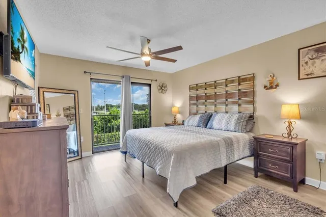 a bedroom with a large bed and a chandelier