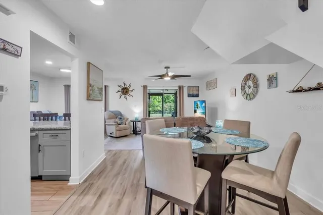 a view of a dining room with furniture wooden floor and a rug