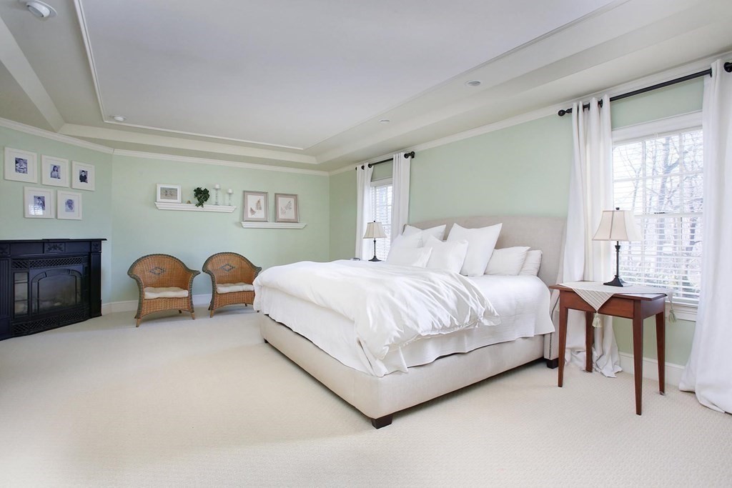 24 Arlington Road Brookline, MA 02467 - Photo 13 of 25 a spacious bedroom with a bed and a table