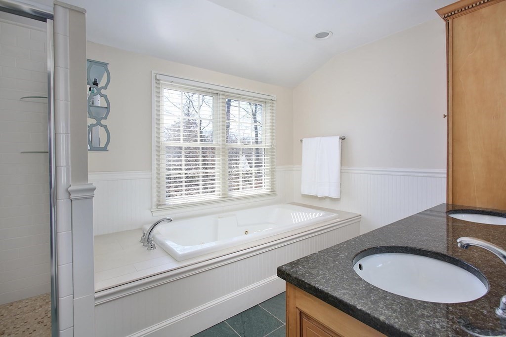 24 Arlington Road Brookline, MA 02467 - Photo 14 of 25 a bathroom with a granite countertop sink and a mirror