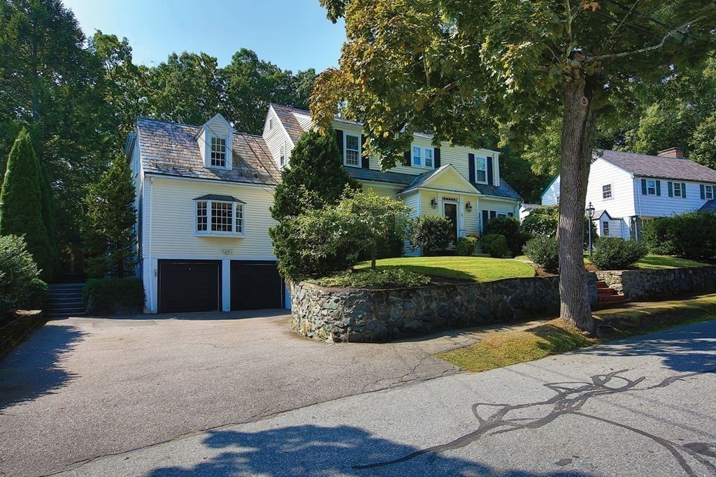 24 Arlington Road Brookline, MA 02467 - Photo 3 of 25 a front view of a house with a garden