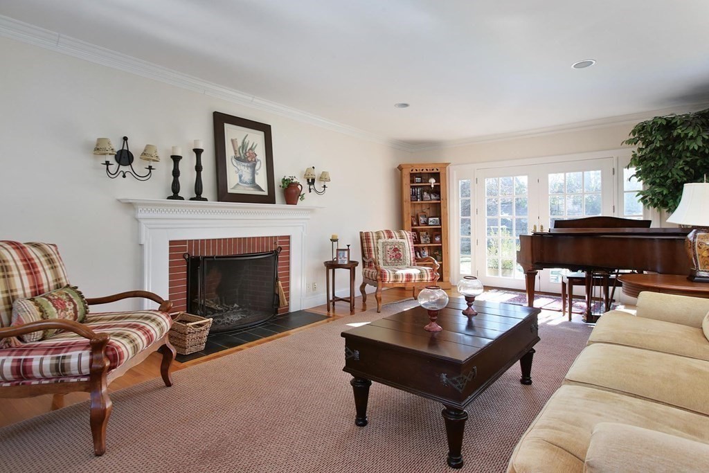 24 Arlington Road Brookline, MA 02467 - Photo 4 of 25 a living room with furniture and a fireplace