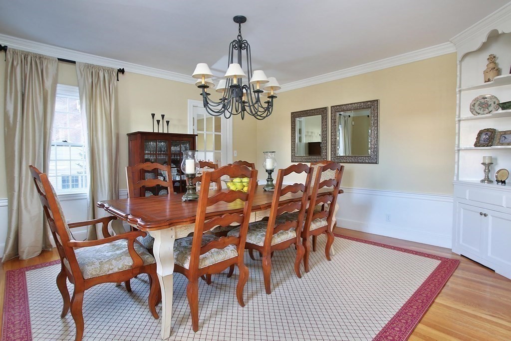 24 Arlington Road Brookline, MA 02467 - Photo 5 of 25 a dining room with furniture a chandelier and wooden floor