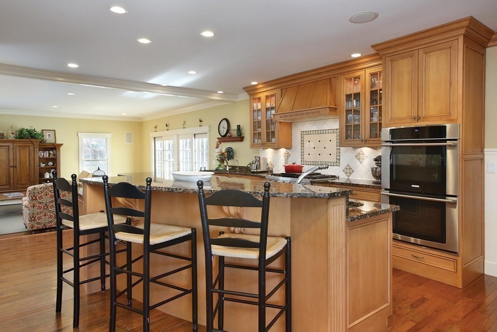 24 Arlington Road Brookline, MA 02467 - Photo 7 of 25 a kitchen with a table chairs refrigerator and cabinets