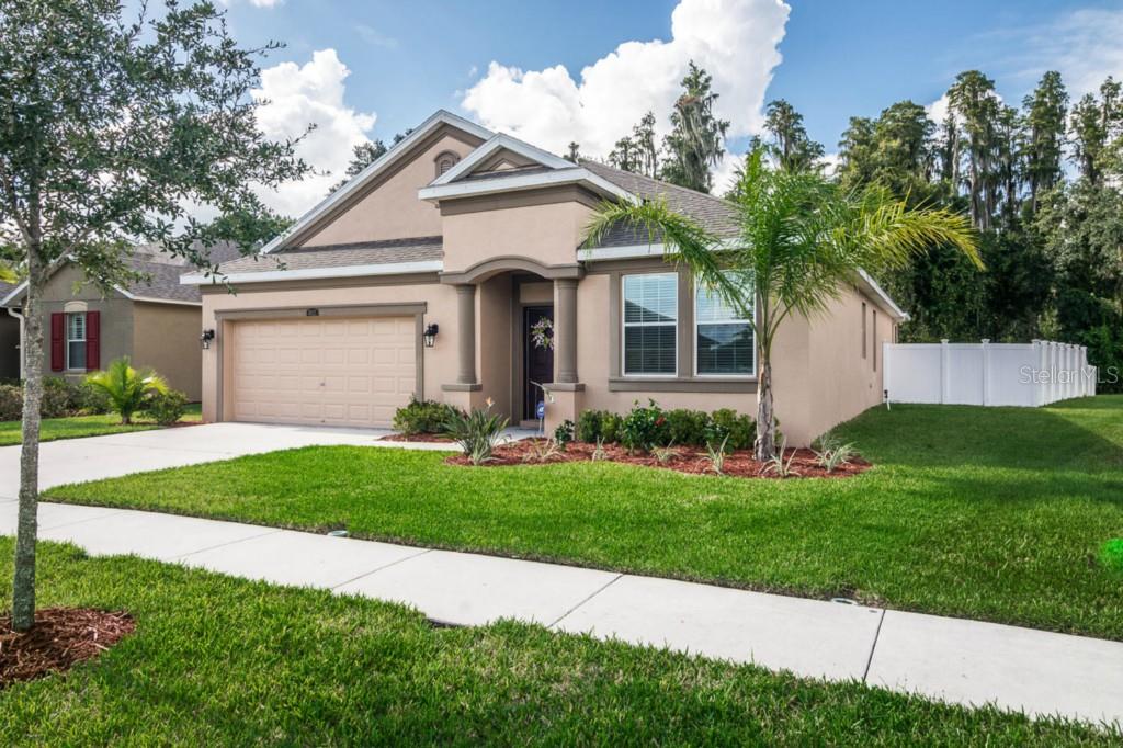4021 Pacente Loop Wesley Chapel, FL 33543 - Photo 1 of 1 a front view of a house with a yard and garage