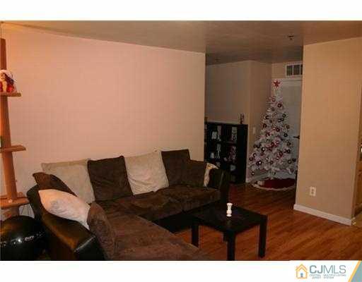 1115 Edpas Road New Brunswick, NJ 08901 - Photo 3 of 8 a living room with furniture and wooden floor