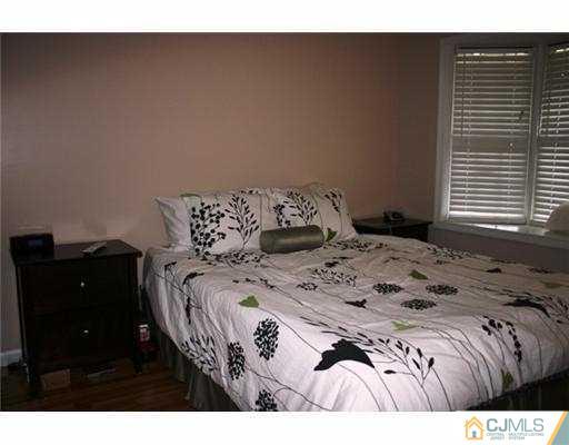 1115 Edpas Road New Brunswick, NJ 08901 - Photo 6 of 8 a bedroom with a bed and a closet