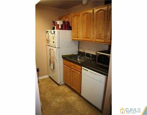 1115 Edpas Road New Brunswick, NJ 08901 - Photo 8 of 8 a kitchen with a refrigerator and a stove