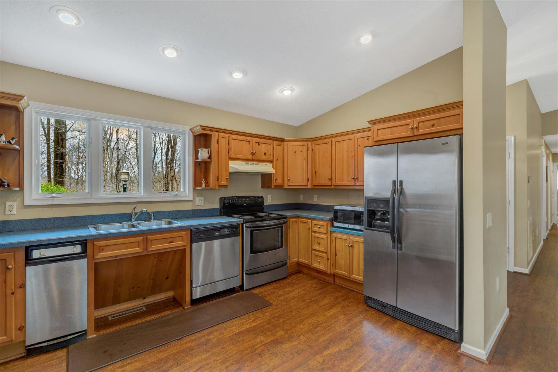 95 Echowood Lane Hardy, VA 24101 - Photo 13 of 46 a kitchen with stainless steel appliances granite countertop a refrigerator a stove and a sink