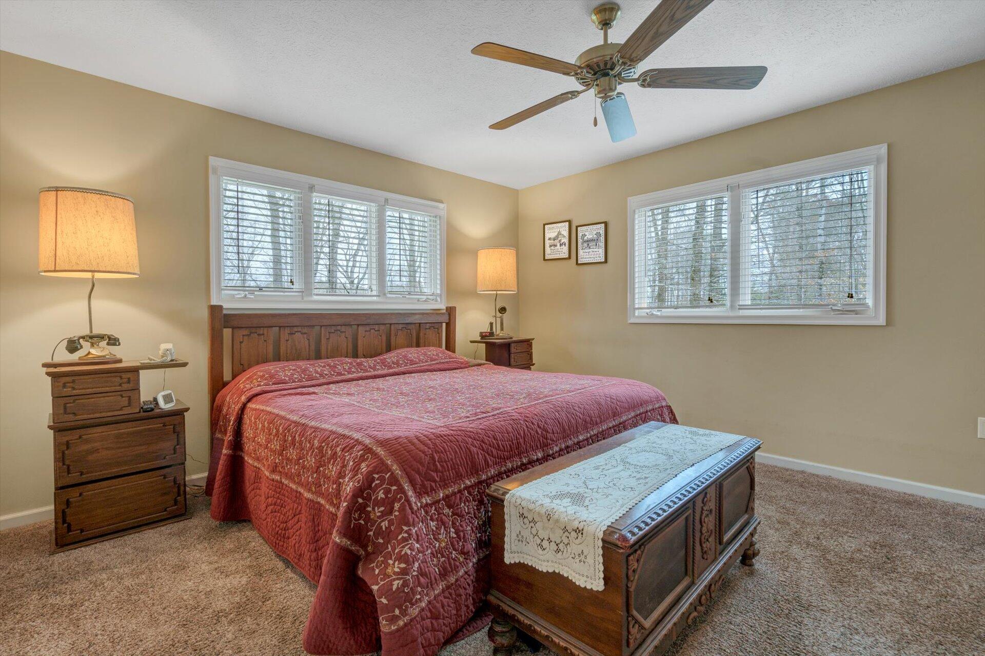95 Echowood Lane Hardy, VA 24101 - Photo 17 of 46 a spacious bedroom with a bed a dresser and a chandelier